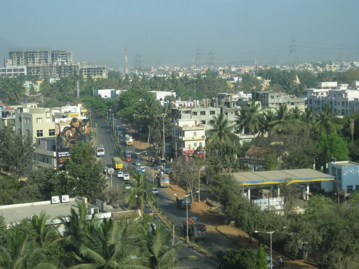 the view from an elevated area looking down on the city and trees