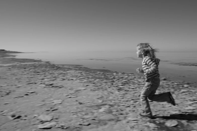  running on beach near water in black and white po