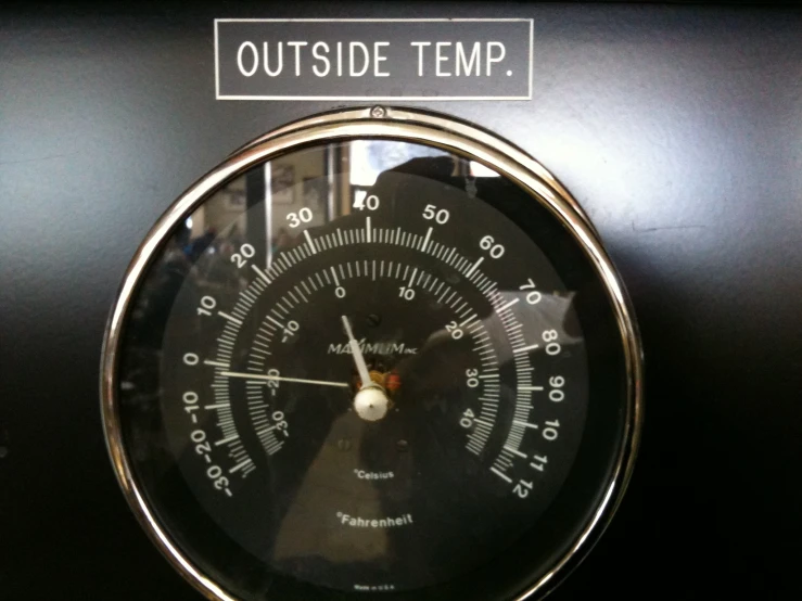 a black and silver clock and the words outside temp