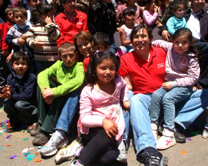 a group of children sitting on the ground