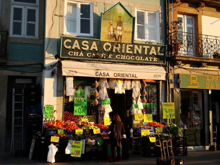 people are outside a small chocolate shop