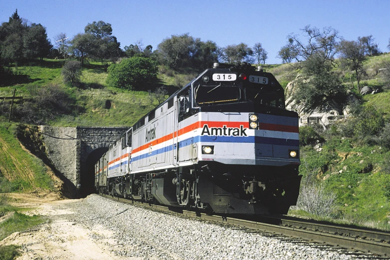 an amtrak train making its way through a rocky tunnel