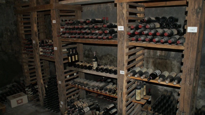 wine bottles sitting in a large room on some shelves