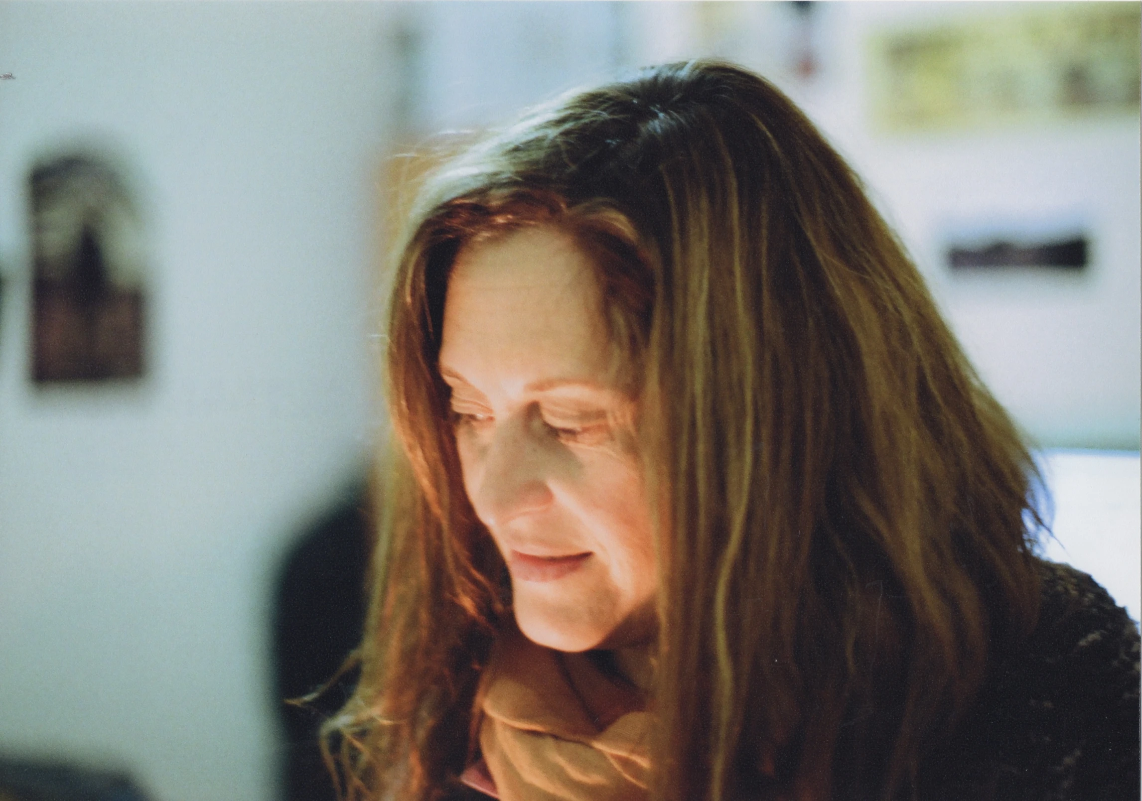 a woman staring down at her cell phone