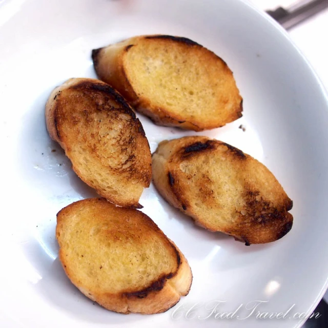 four fried bread slices on a white plate