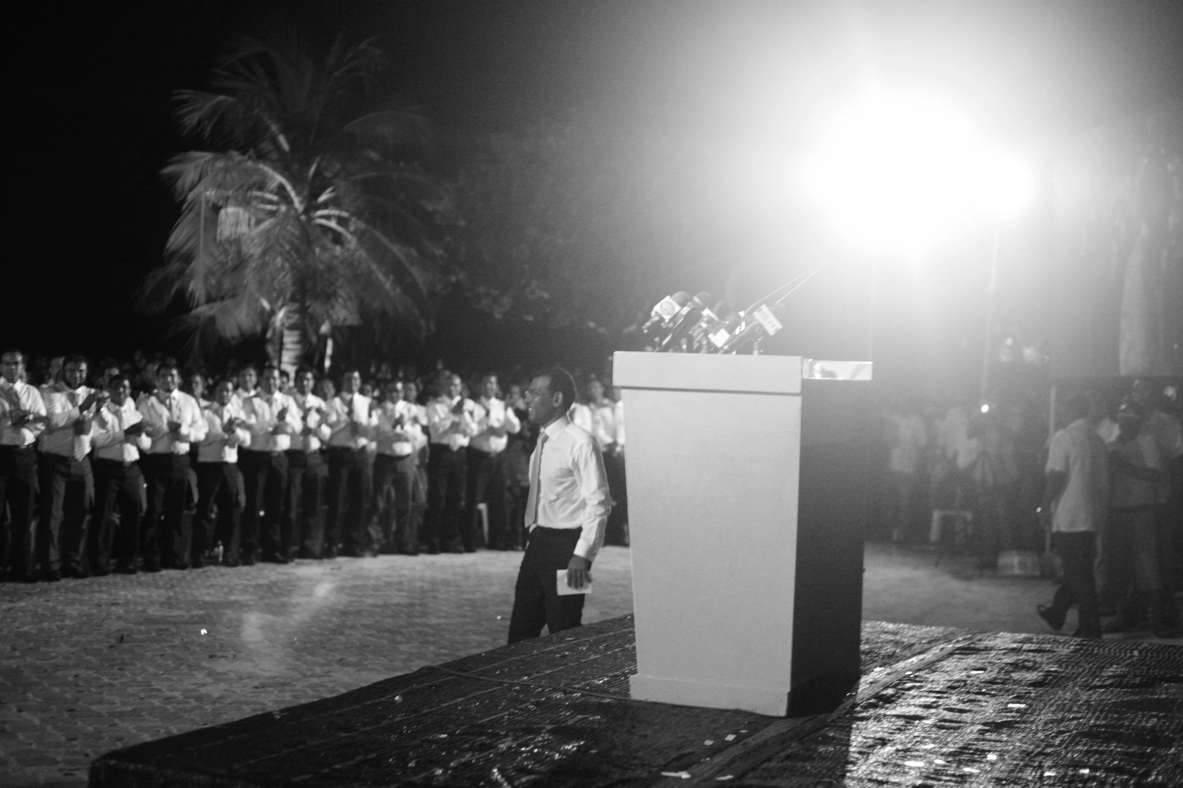 a group of people that are standing in front of a microphone