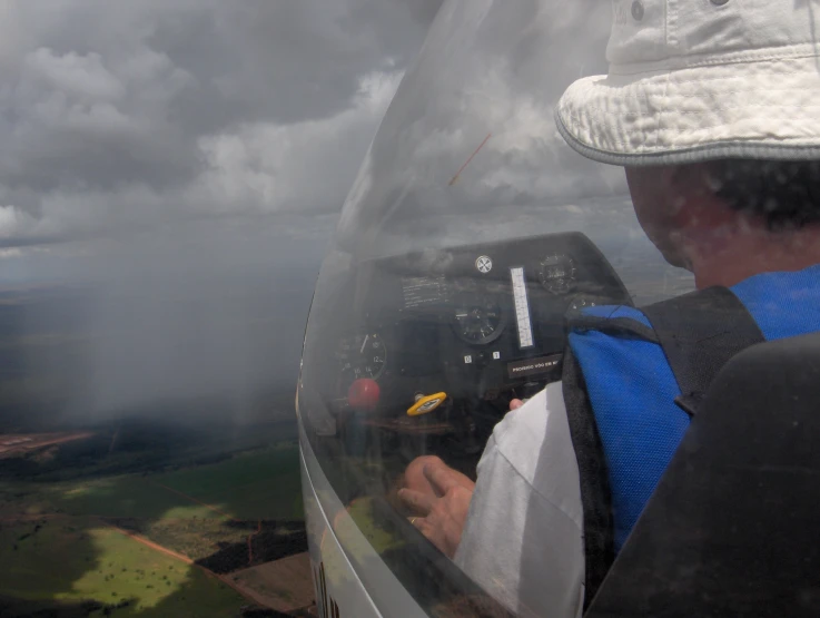 a man flying over land next to a large airport