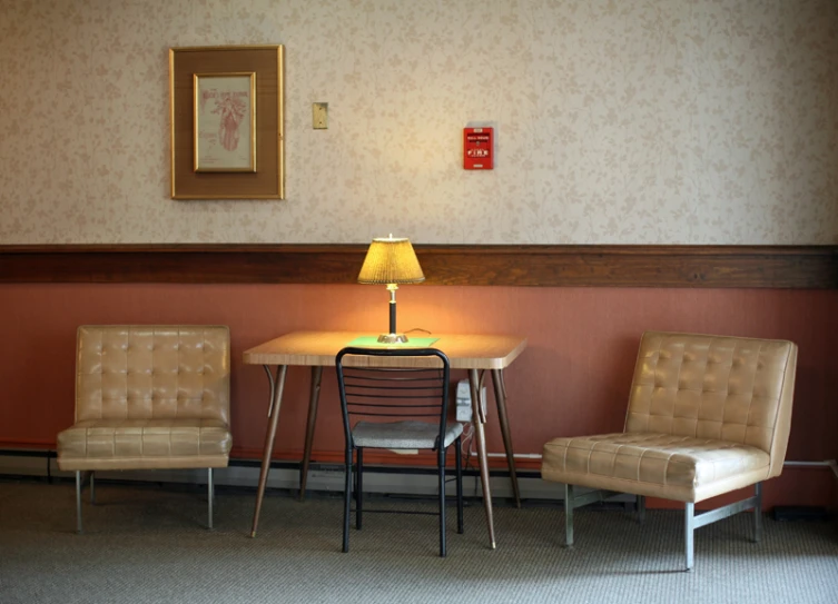 a tan chair and a table in a room