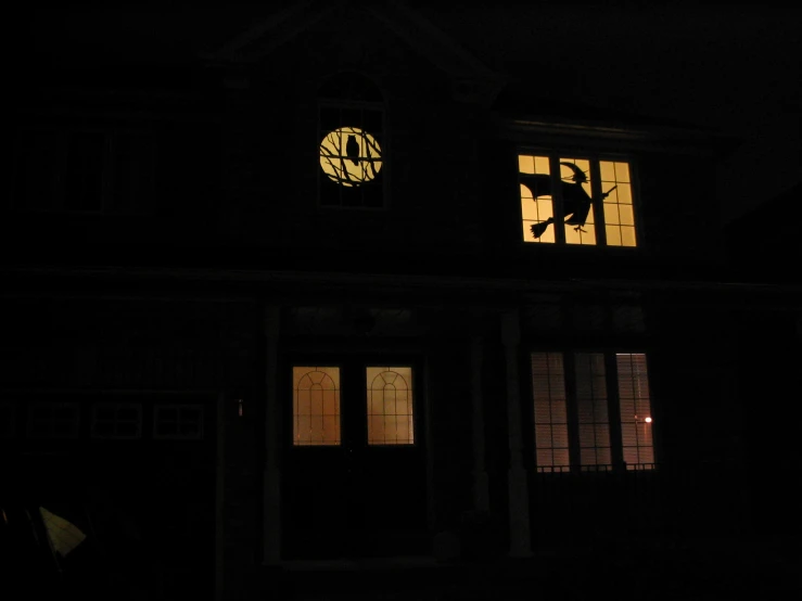 a silhouetted man in the night, from inside a house
