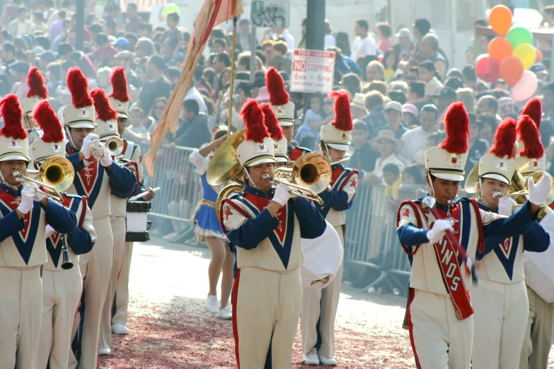 several guys in dress uniforms playing different music instruments