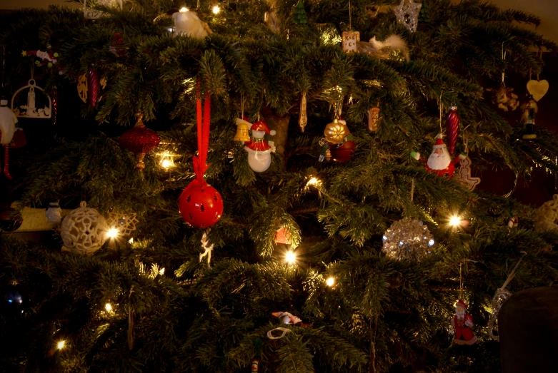 a christmas tree with ornaments and lights on it