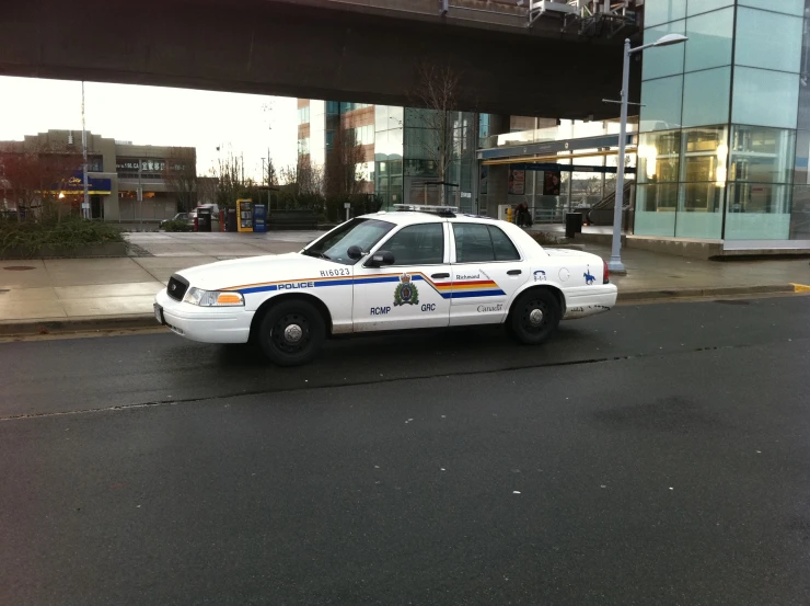 police car parked on the street in front of the building