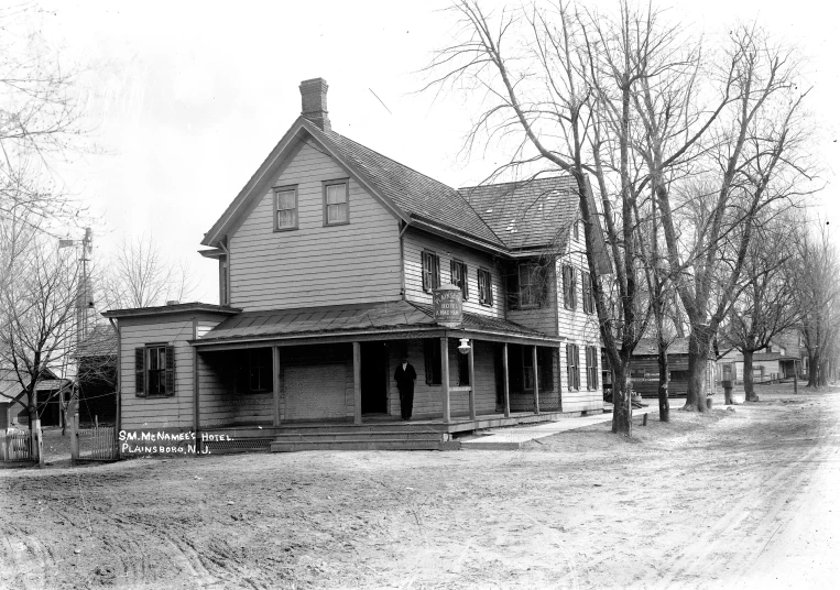 an old po of a house with some trees in front