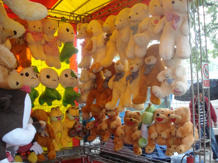 many teddy bears hanging from poles at an amut park