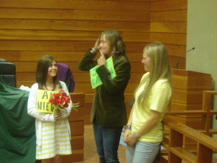 four girls in a school choir with a sign