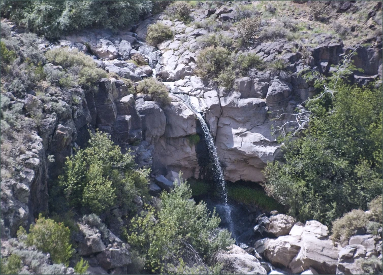 a waterfall in the middle of a gorge