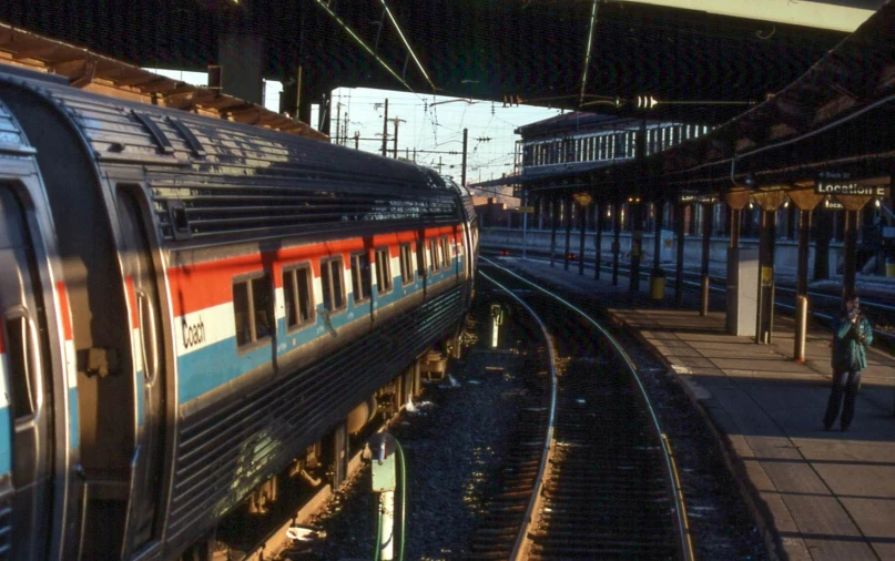 people on a platform next to the train at a station