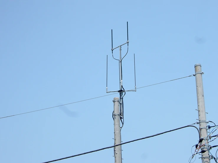 multiple antenna towers on blue sky with no cloud