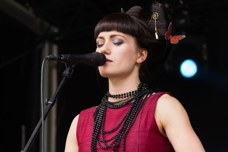 a woman standing on top of a stage with a microphone