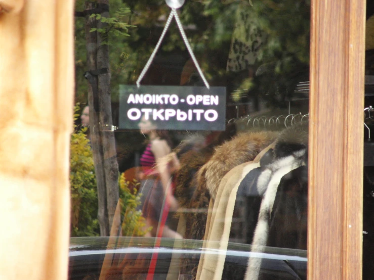 a shop window reflecting clothes on display