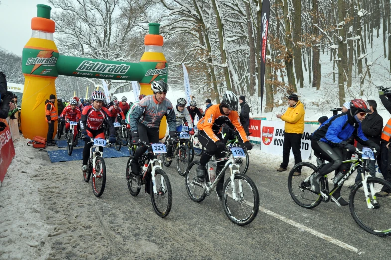 a line of people in coats and bikes on the road