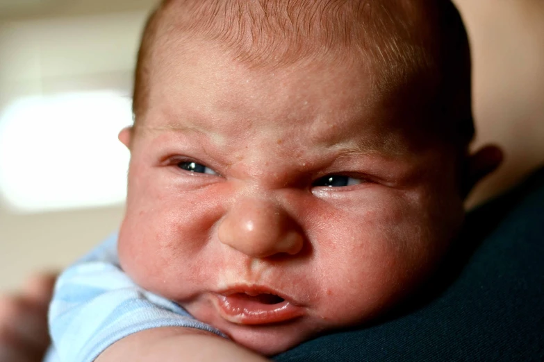 a baby with an angry expression on his face