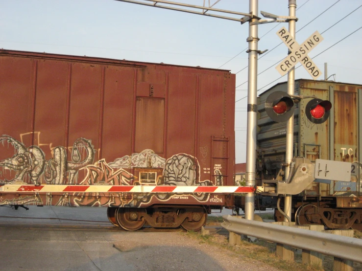 a train on a track going by some graffiti