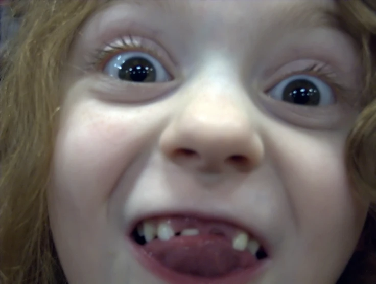 a close up of a child's face with very large eyes