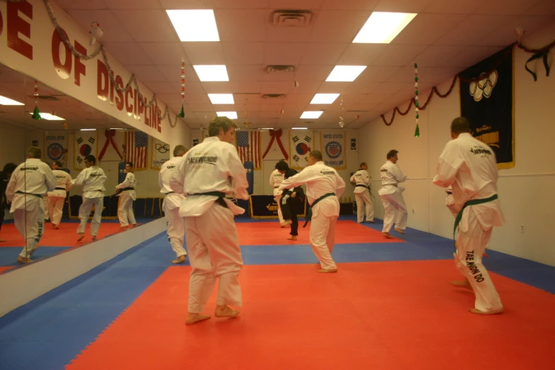 some men are doing some karate in the gym