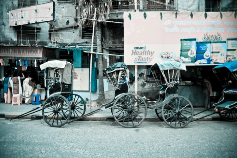 a side view of a building that has two buggies parked by it