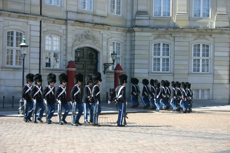 many men are walking in front of a building