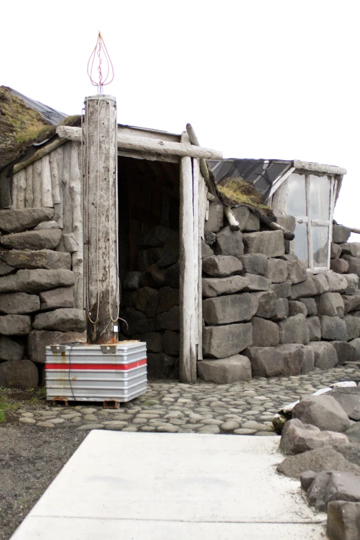 a old building with some grass growing on the roof