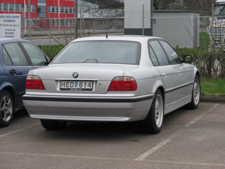 a silver car parked next to another one in a parking lot