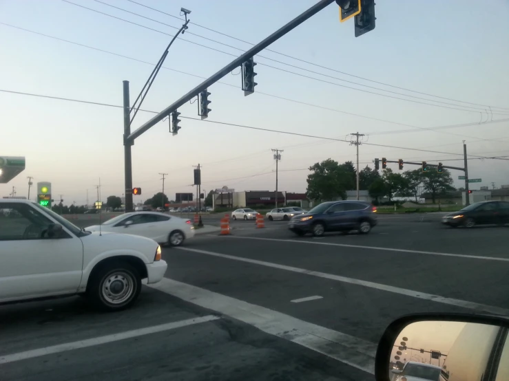 a street intersection with traffic in it and cars driving