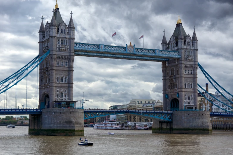 a boat travels through a river under a bridge