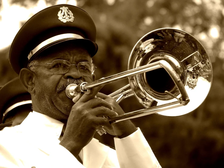 a man in uniform and beret playing the trombone
