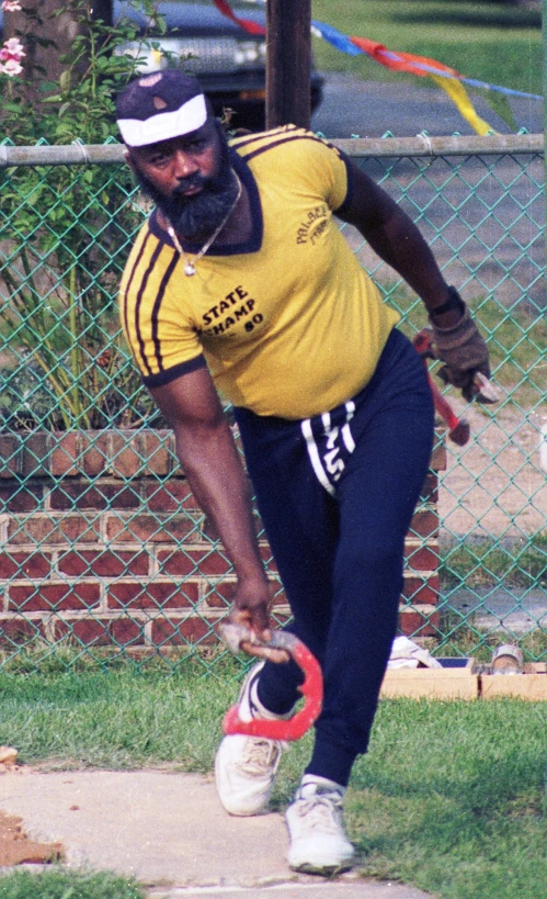 a man in a yellow shirt playing frisbee
