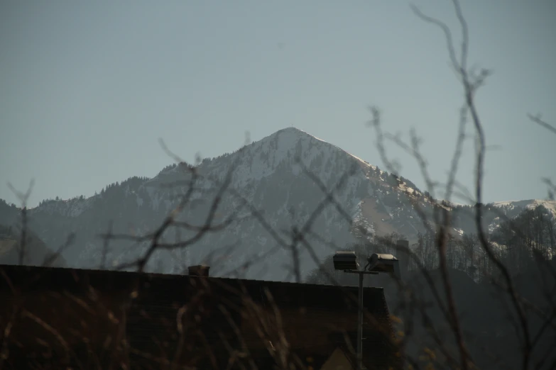 a house sitting in front of a snowy mountain