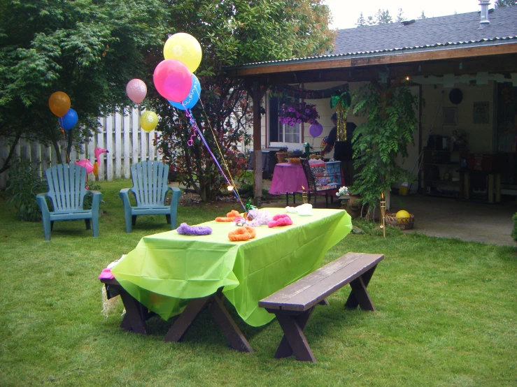 a table set up with many balloons on top of it