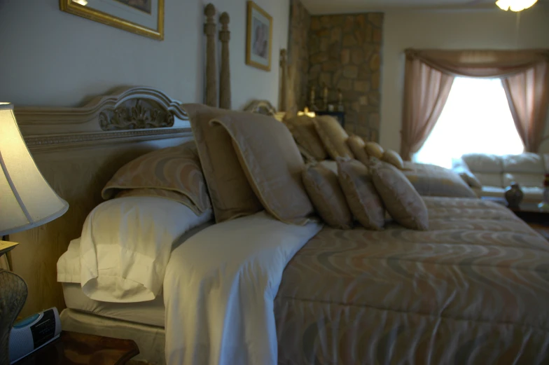 two side tables on either side of a bed with folded pillows