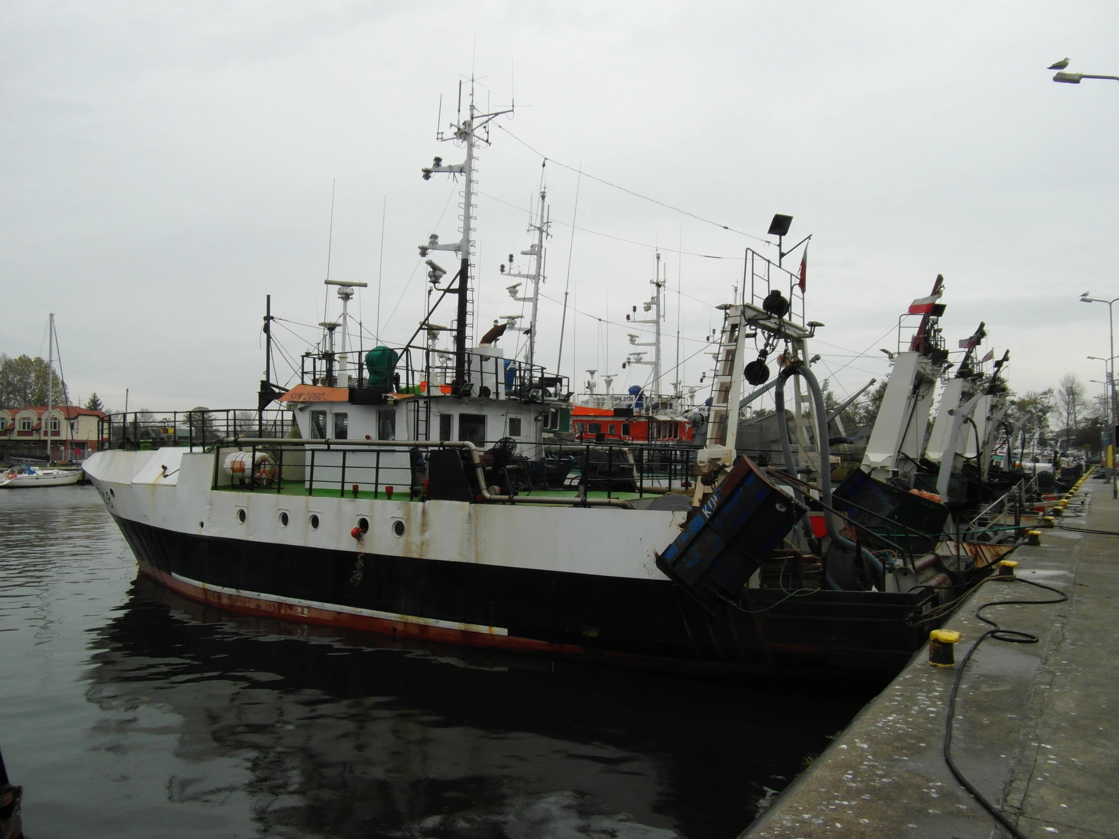 a black and white ship docked on a water way