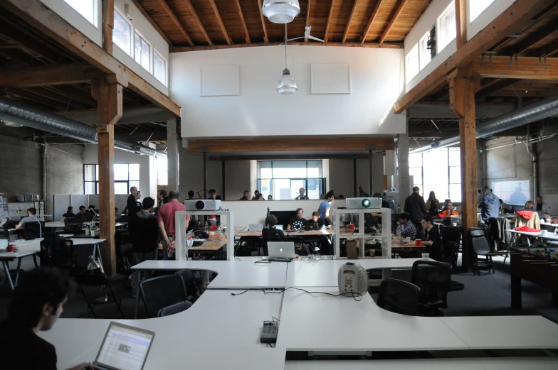 several people working on their computers in an office