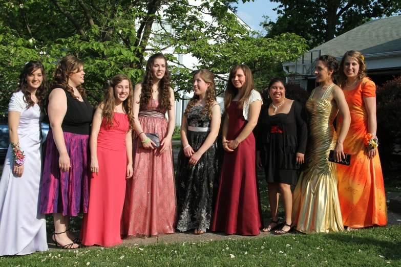 a group of young women standing next to each other on a field