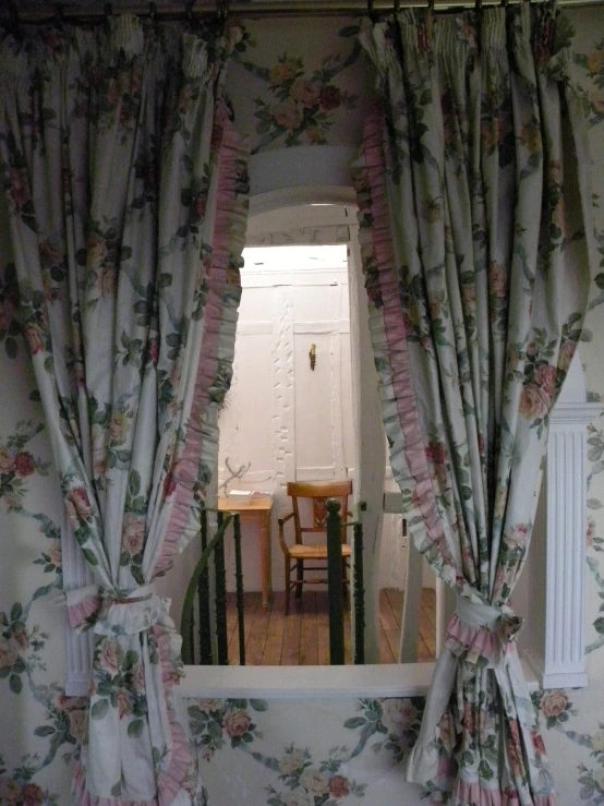 a picture of a dining room with curtains drawn up