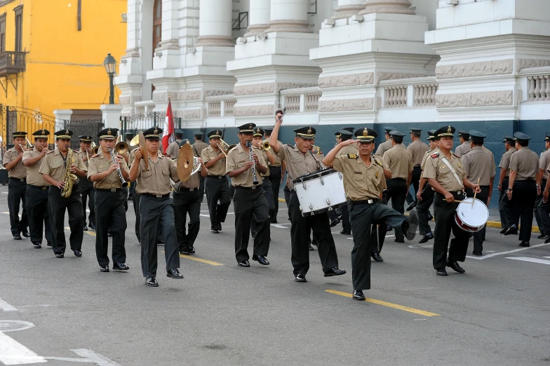 a military marching band playing in the street