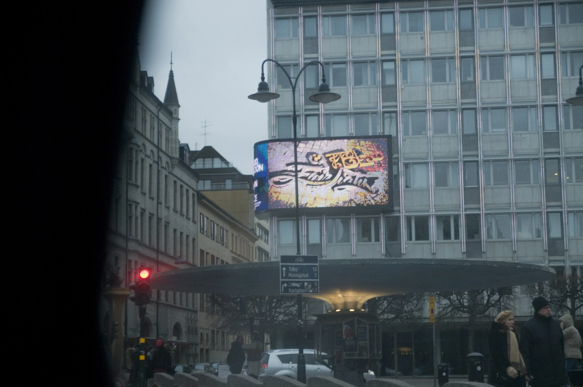 a big screen billboard on the side of a building