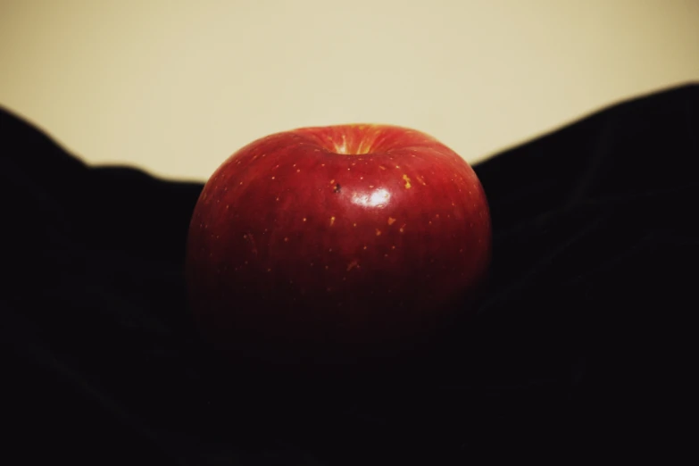 a red apple with a yellow face