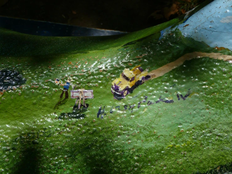 a fake display features people and vehicles in the grass