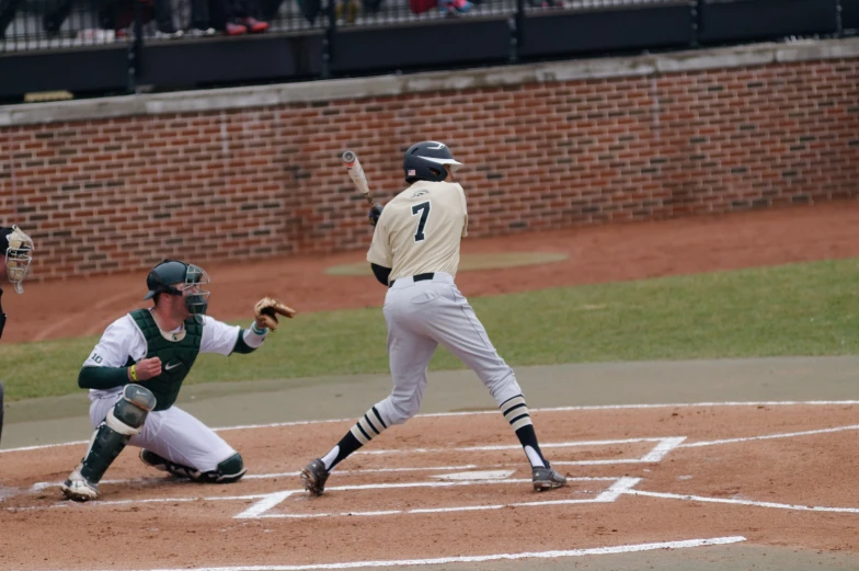 baseball players on a field and a pitcher with a bat