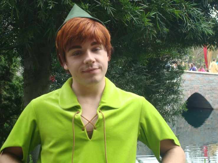 a red haired man wearing a green hat and green shirt